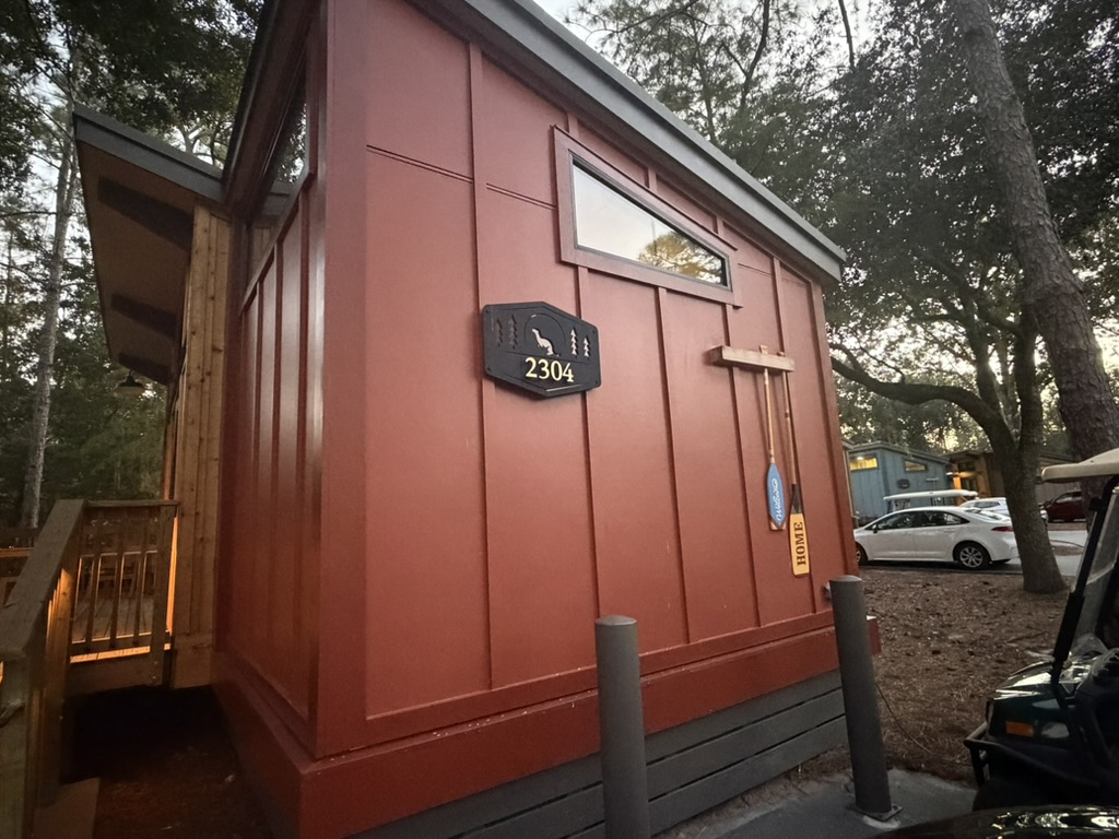 A red Fort Wilderness cabin numbered 2304 in Loop 2300 at Disney's Fort Wilderness Resort.